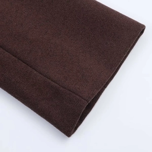 Detailed close-up of dark coffee wool blend coat showing high-quality twill texture and stitching