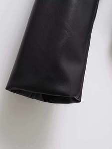 Detailed close-up of premium black faux leather texture with neat stitching and smooth lining