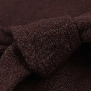 Close-up of deep brown knitted fabric showing premium twill texture and soft thick material