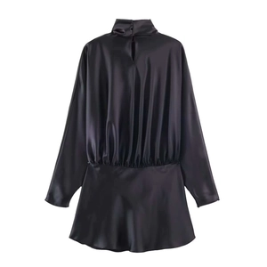 Detailed view of black satin mini dress featuring elegant back keyhole cutout and button
