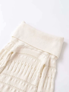 Detail of off-white turtleneck knitwear with ribbed texture and hollow-out patterns