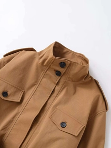 Detail shot of the khaki utility jacket collar, epaulettes, and black buttons finish