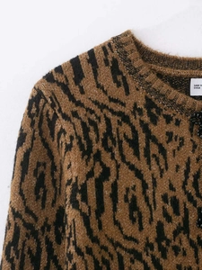 Detailed view of the tiger-patterned knit cardigan with black bead accents and fuzzy texture