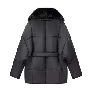 Women's black puffer coat with large faux fur collar and waist belt from rear view