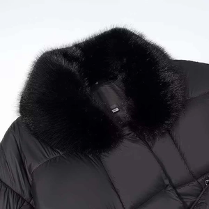 Detail of a black winter jacket featuring a large fluffy faux fur collar and size S tag