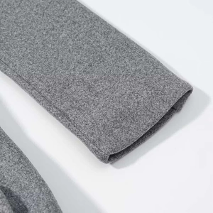 Detailed macro view of the sleeve cuff stitching on this grey wool coat for women