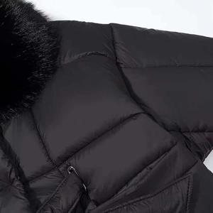 Women's black quilted winter coat featuring a luxurious thick faux fur collar and matte finish