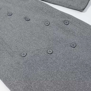 Women's long grey wool coat featuring irregular double-breasted black buttons detail