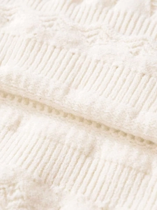 Macro detail of high-quality white ribbed knit fabric with delicate embossed patterns