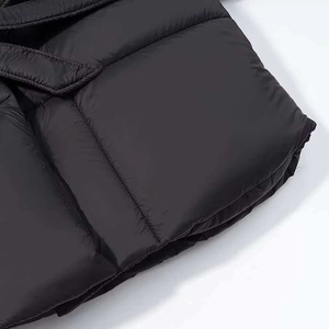 Close-up of horizontal quilting and matte windproof fabric on a black winter puffer jacket