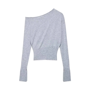 Detailed flat lay of a grey off-shoulder knit sweater with fine ribbed cuffs and fabric