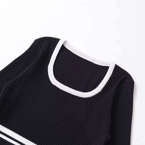 Women's black long sleeve knit top with contrast white U-neck and ribbed texture details
