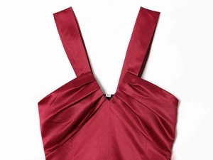 Detail of burgundy satin dress showing V-neckline, pleats, and size M label