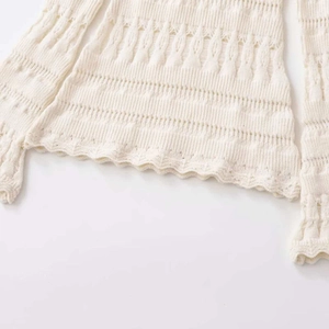Elegant cream knit long sleeve top with pointelle hollow design and scalloped hemline