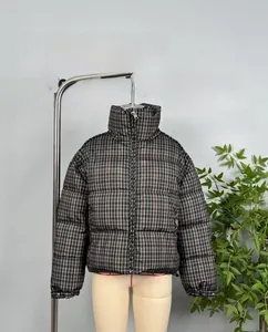 Detail of high stand collar and vintage plaid quilted pattern on this winter jacket