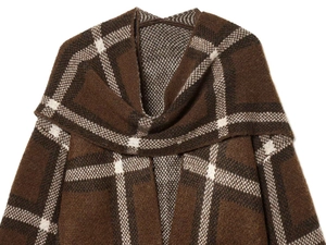 Detail of a brown checkered knitted shawl with a draped collar and thick textured fabric