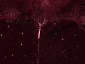 Detail of burgundy velvet dress featuring rhinestone accents and hidden back zipper