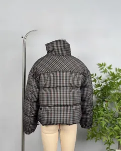 Close-up of vintage plaid quilted texture and detailed back stitching on the jacket