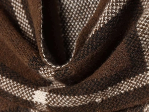 Macro view of plaid knit fabric with soft texture and detailed brown pattern