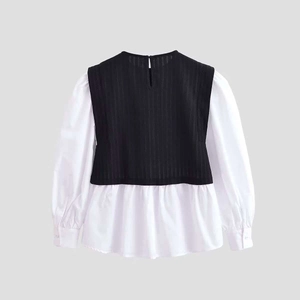 Women's two-piece style long sleeve top with black knit vest and white shirt hem