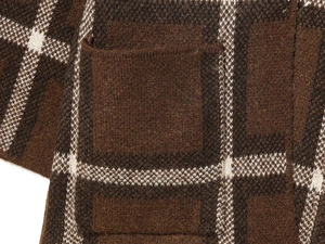 Macro shot of brown plaid knit jacket showing textured fabric and patch pocket detail