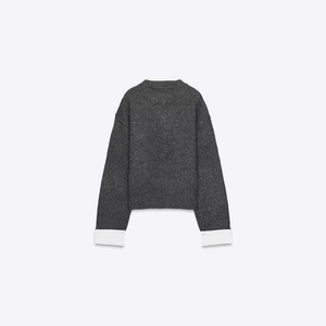 Minimalist grey knit sweater featuring contrast white wide-cuff sleeve details