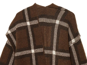 Close-up of brown and white checkered knit sweater texture and back shoulder area