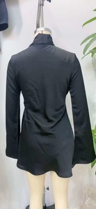 Detail of black satin high neck mini dress featuring flared sleeves and slim fit cut