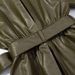 Close-up of olive green faux leather jacket with adjustable waist belt and pleated detail