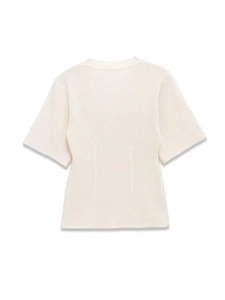 Close-up of cream short-sleeve knit top showing vertical ribbed texture and crew neck