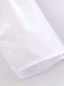 Detail shot of the precise stitching and high-quality white fabric of the layered shirt
