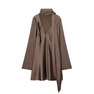 Detail view of glossy brown satin fabric and stylish V-neck scarf collar design