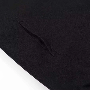 Detailed macro view of black wool coat showing hidden side pocket and fabric texture