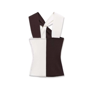 Close-up of ribbed knit texture and metal buckle on black and white halter top
