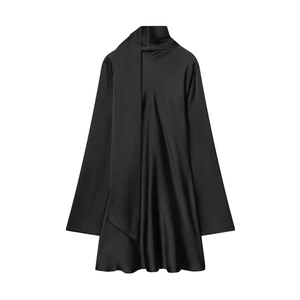 Detail of elegant black satin dress featuring high neck with flowing tie and silky texture