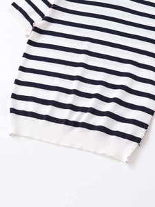 Close-up of blue and white striped knit shirt showing ribbed cuffs and fine stitching