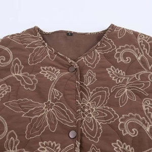 Brown quilted jacket with floral embroidery and classic round buttons in a flat lay view