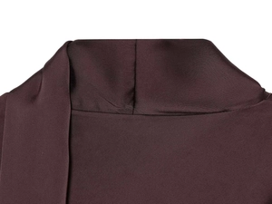Detailed close-up of the pleated high neck on a shiny purple satin V-neck dress