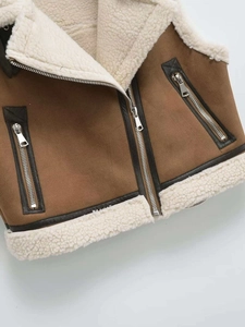 Close-up of brown faux suede vest with cream faux shearling lining and zipper details