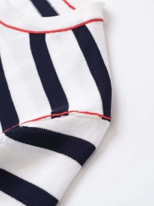 Detail of striped knit top with white base, navy stripes and red seam stitching