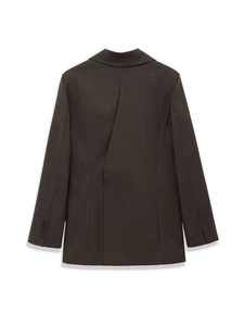 Detail of dark brown wool-like blazer back featuring unique asymmetric pleated design