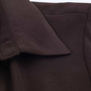 Detail of the high-quality chocolate brown fabric and precision stitching on the collar