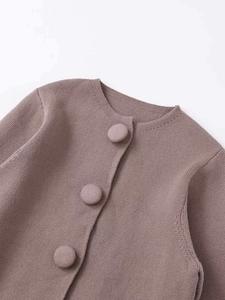 Detail von Strickjacke mit Rundhalsausschnitt und stoffbezogenen Knöpfen in Mauve