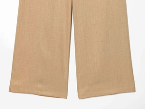 Close-up of khaki wide-leg trousers showing premium twill fabric and neat hem stitching
