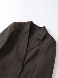 Close-up of charcoal grey single-breasted blazer notched lapels and fabric texture