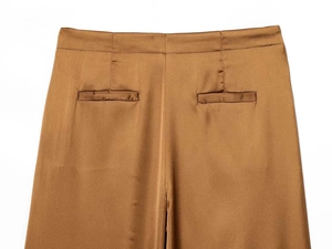 Detail view of high waist satin wide leg trousers with rear welt pockets in bronze