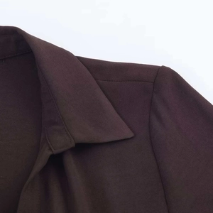 Detailed close-up of dark coffee shirt dress collar and shoulder with ribbed texture