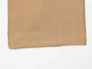 Macro shot of khaki wide-leg trousers showing high-quality hem stitching and woven texture