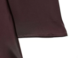 Detail of high-quality dark burgundy satin fabric showing smooth texture and fine stitching