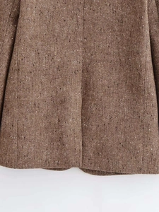 Detailed macro view of the vintage brown herringbone wool texture of this stylish blazer